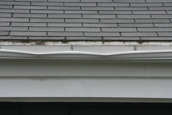 Collapsed gutter on a grey roof