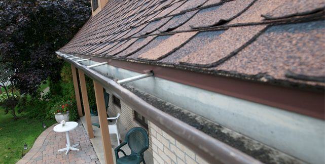 Rain gutter installed with standard hangers
